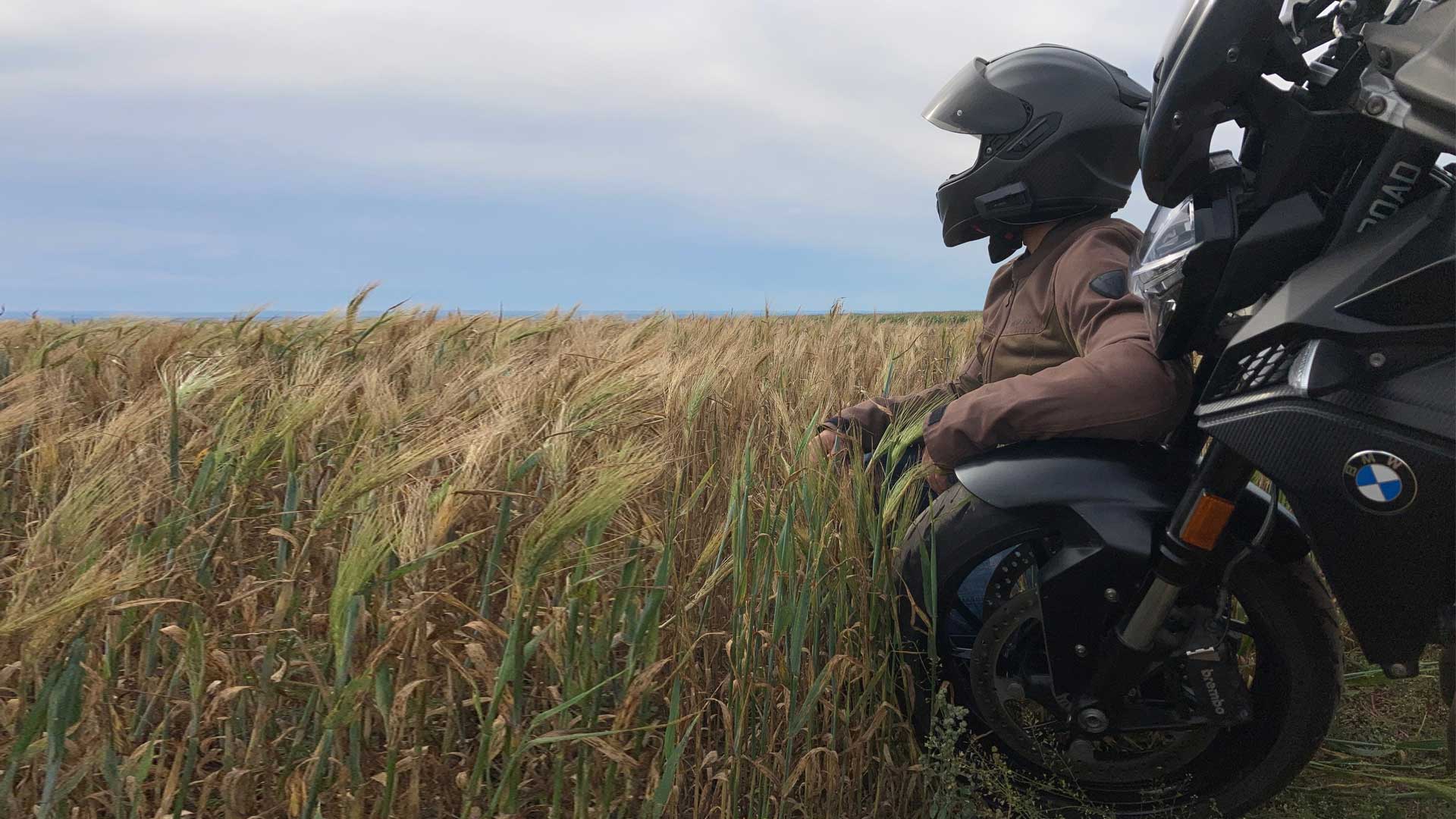 Solo motorcycle traveler in a field
